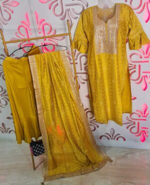 Ready to wear three piece suit with tilla work . Muslin kurta and dupatta in bandhani print with tilla work on yoke and all four sides of dupatta . Finished with embroidery and samosa lace on sleeves . Tassles on four corners of dupatta.