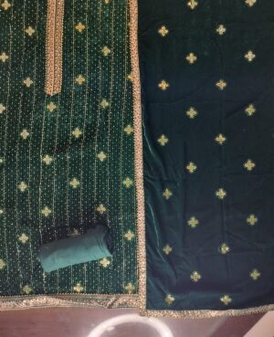 Semi Stitched Emerald Green Soft Micro Velvette all over sequined as well as kasab thread work in gold on front kurta with banarasi long Kurta patti detailing and samosa lace finishing on sleeves/ front and back hemlines .